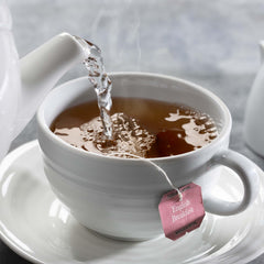 Close-up of a Bigelow tea bag highlighting woven texture and quick infusion benefit