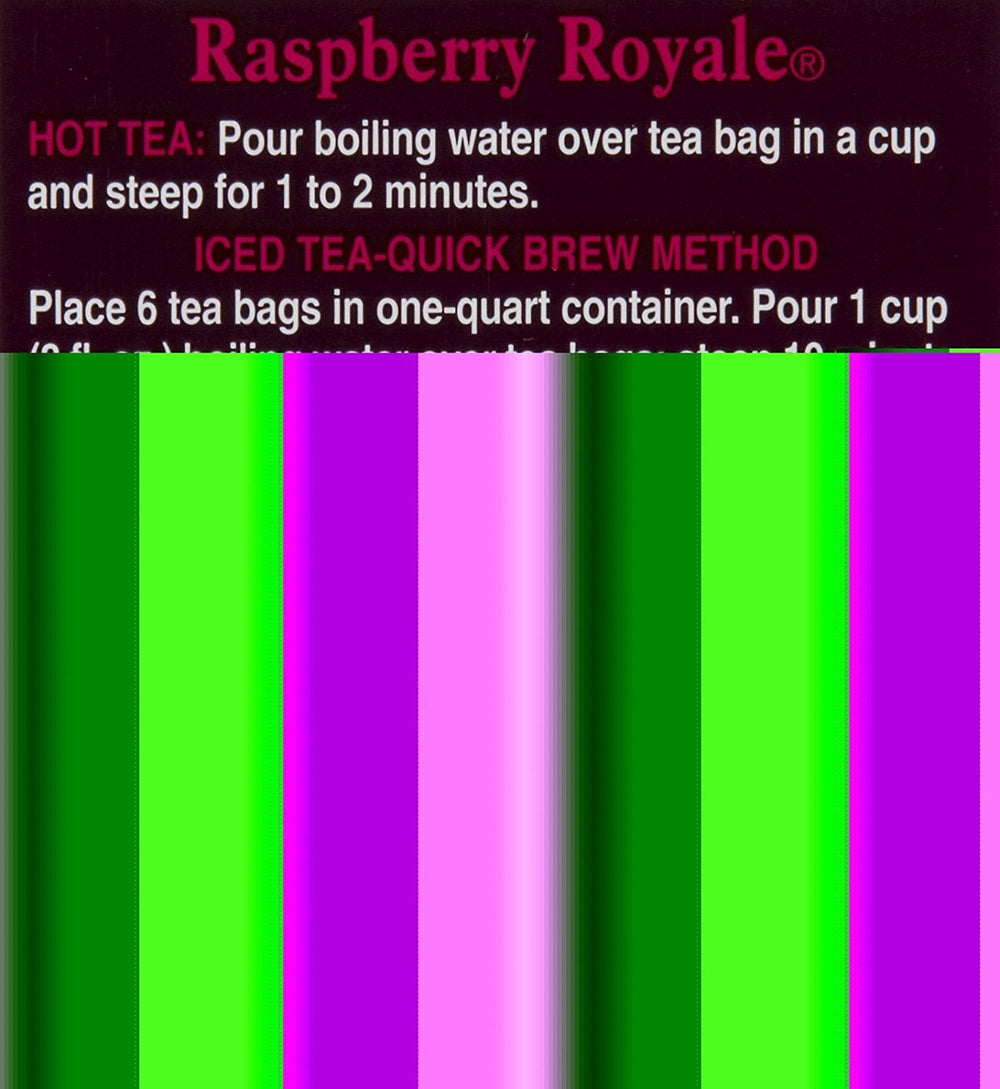 Close-up of Bigelow Raspberry Royale tea bag steeping with visible raspberry-infused color