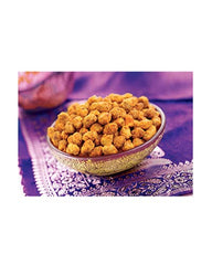 Hand holding Bikaji peanuts to show portion size and convenient on-the-go snack