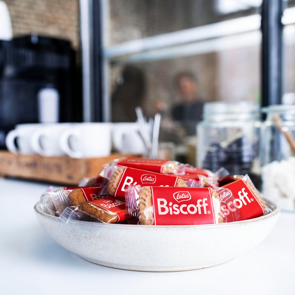 Hand holding a Biscoff biscuit showing scale and single‑serve portion