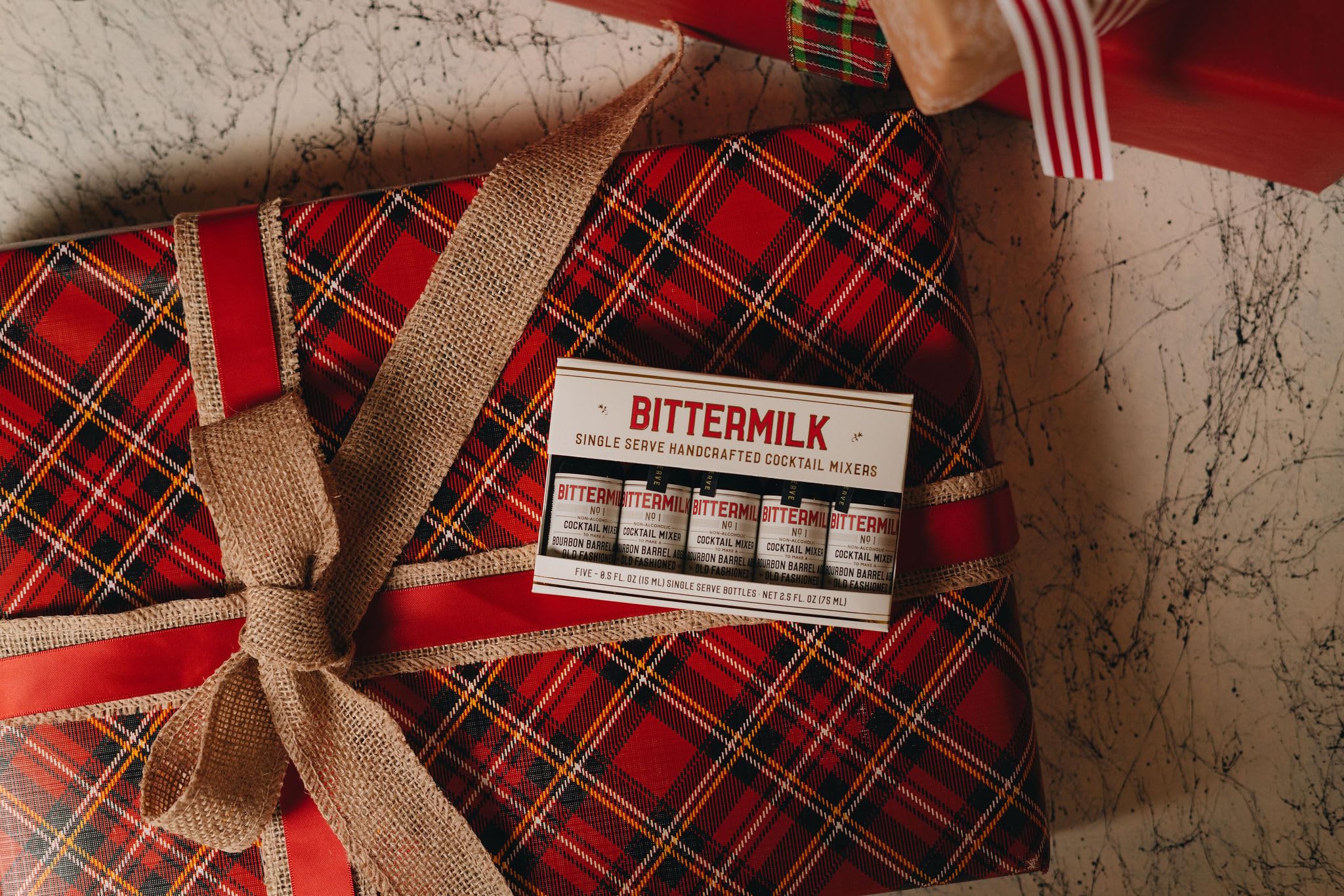 Bittermilk being poured over ice showing quick cocktail assembly benefit