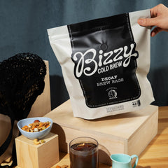 Bizzy decaf brew bag close-up revealing pre-portioned coarse grounds and easy steeping