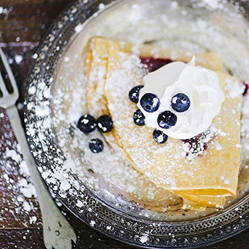 Blackberry Patch syrup being drizzled on pancakes for rich blueberry flavor
