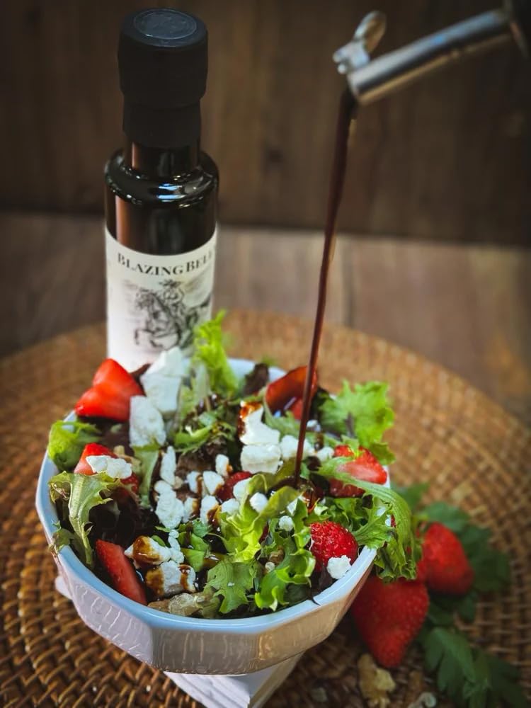 Blazing Bella pouring balsamic with visible thick, syrupy stream