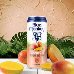 blue monkey close-up pour capturing mango juice texture and gentle bubbles for refreshing appeal