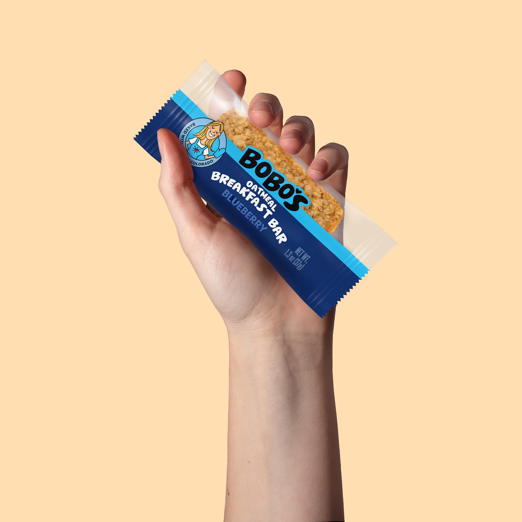 Bobo's bar held in hand demonstrating portable breakfast convenience and energy on-the-go