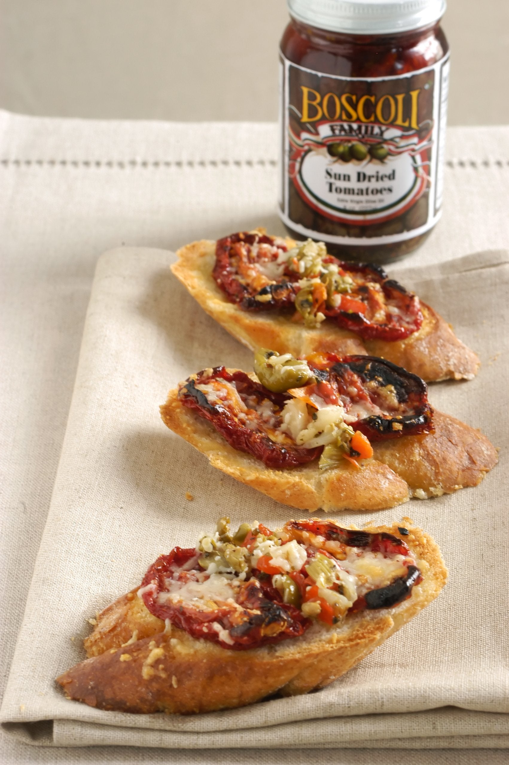 Boscoli Family arranged olives, peppers, capers displaying key ingredients