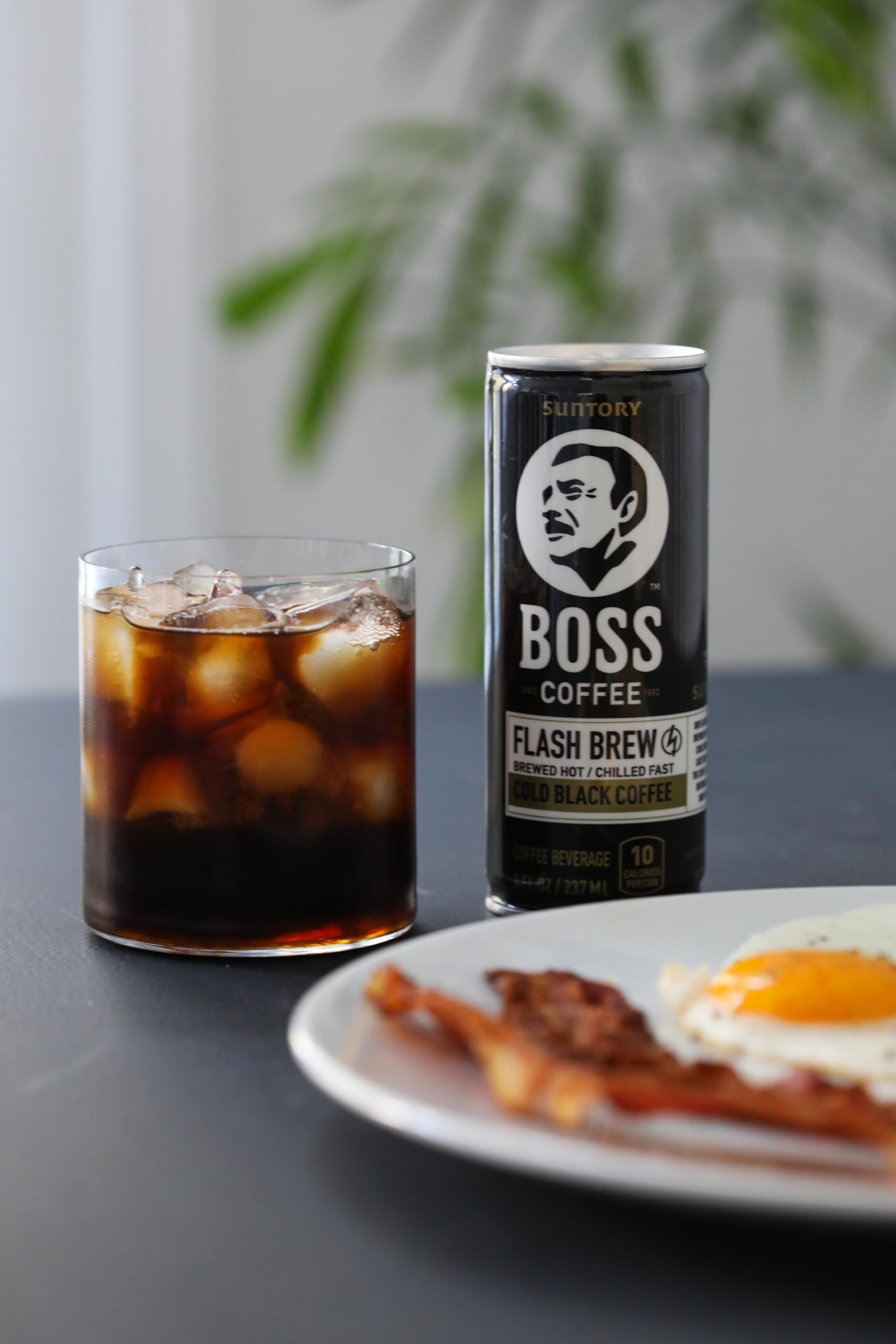 BOSS coffee poured into glass over ice showing crisp iced flavor benefit