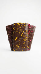 Bouchard close-up of dark chocolate surface and freeze-dried fruit pieces highlighting texture