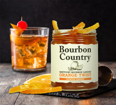 Bourbon Country orange twist perched on an Old Fashioned glass adding citrus aroma and elegance