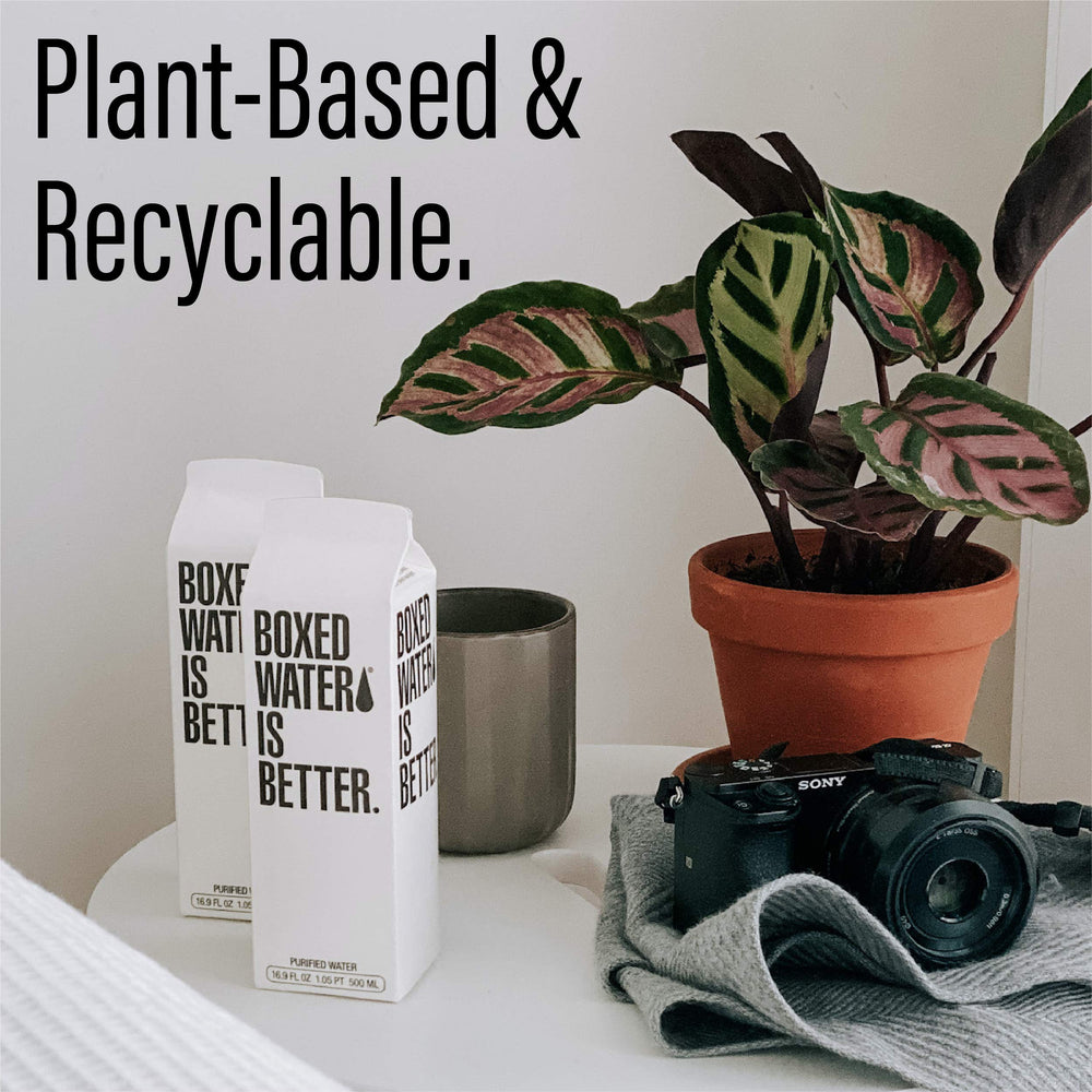 Boxed Water Is Better held in hand showing 16.9 oz scale and portability benefit