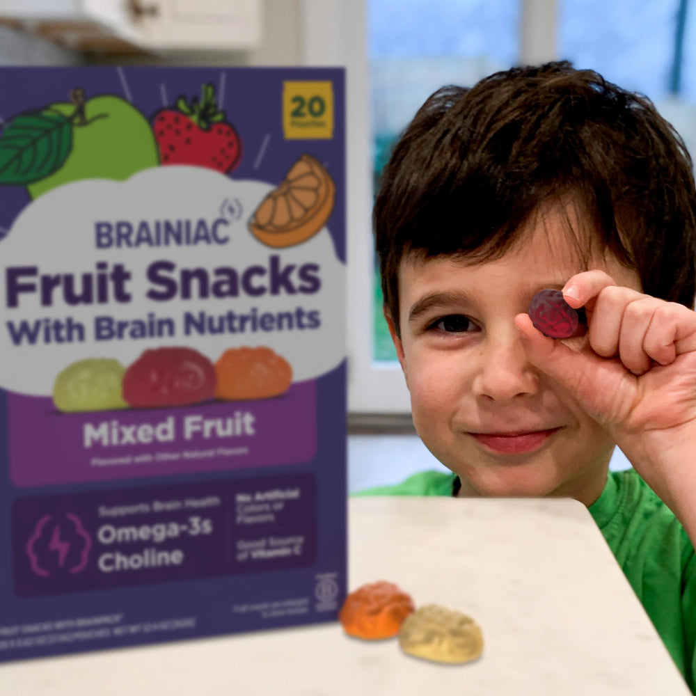Brainiac snack held in adult hand for scale, demonstrates single-serve convenience