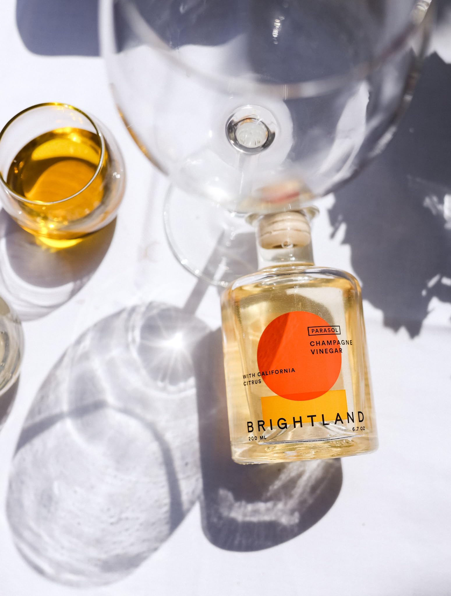 Brightland label and cap detail emphasizing artisanal origins and recyclable glass