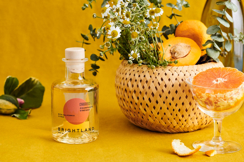 Brightland two 200ml bottles next to a measuring glass to show true scale