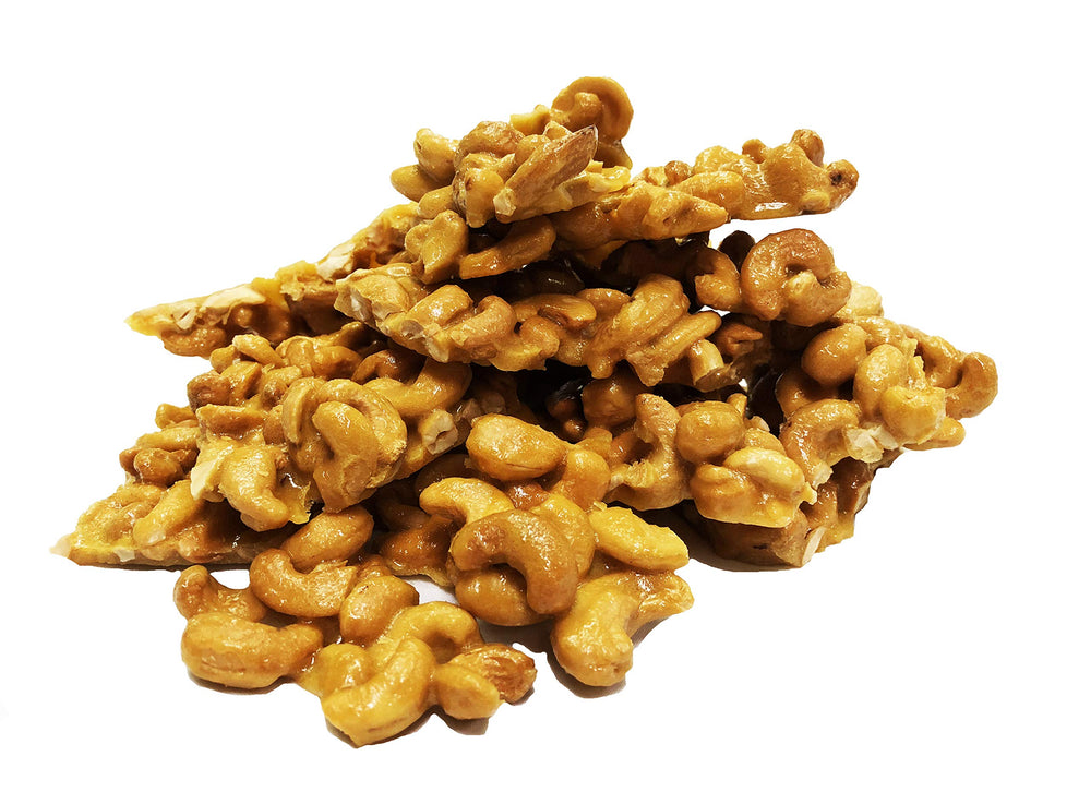 Brittle Brothers brittle held in hands to show 16 oz scale and portion size
