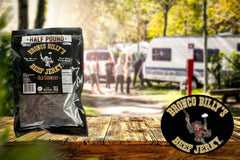 Bronco Billy's jerky strip in hand demonstrating portion size and protein benefit