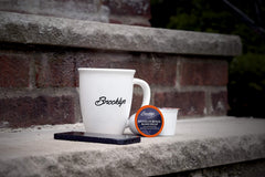 Brooklyn Beans pod inside a Keurig machine during brew, fast single-serve convenience