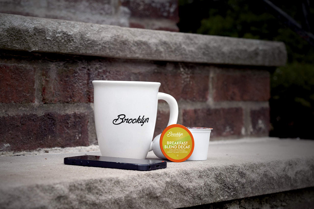 Brooklyn Beans pod in hand to show scale and single-serve portion for consistent brews