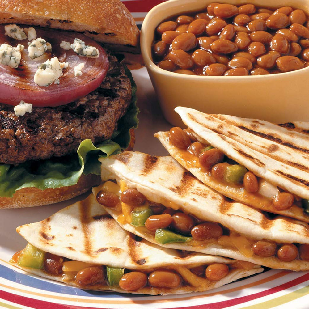 Bush's Best beans plated beside grilled meats as a tasty BBQ side