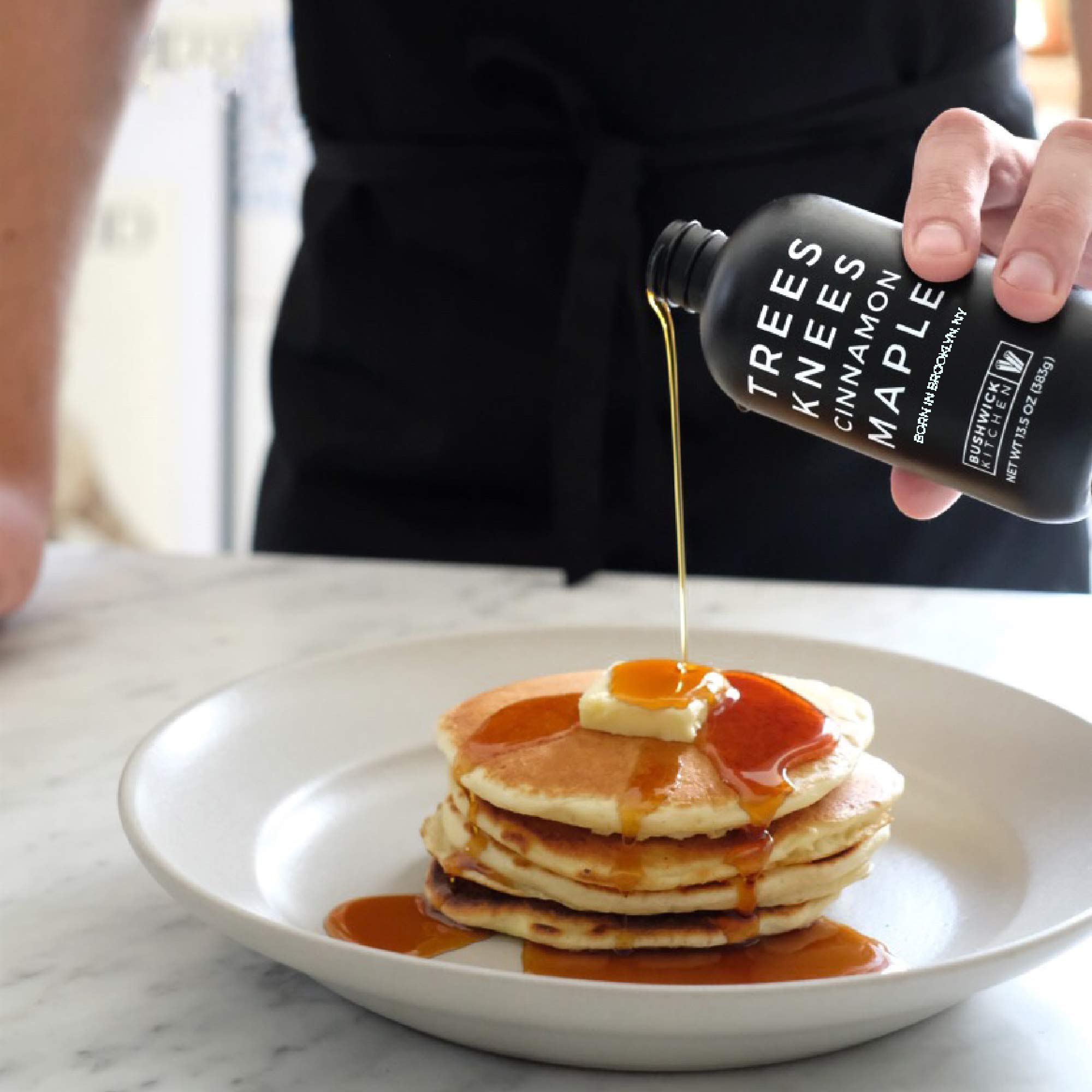 Bushwick Kitchen syrup pouring from bottle to show smooth texture and easy drizzle