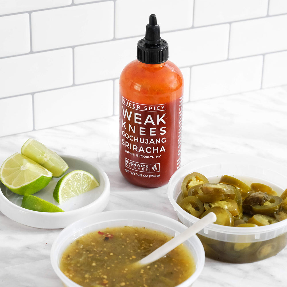 Bushwick Kitchen bottle on kitchen table next to food for serving idea