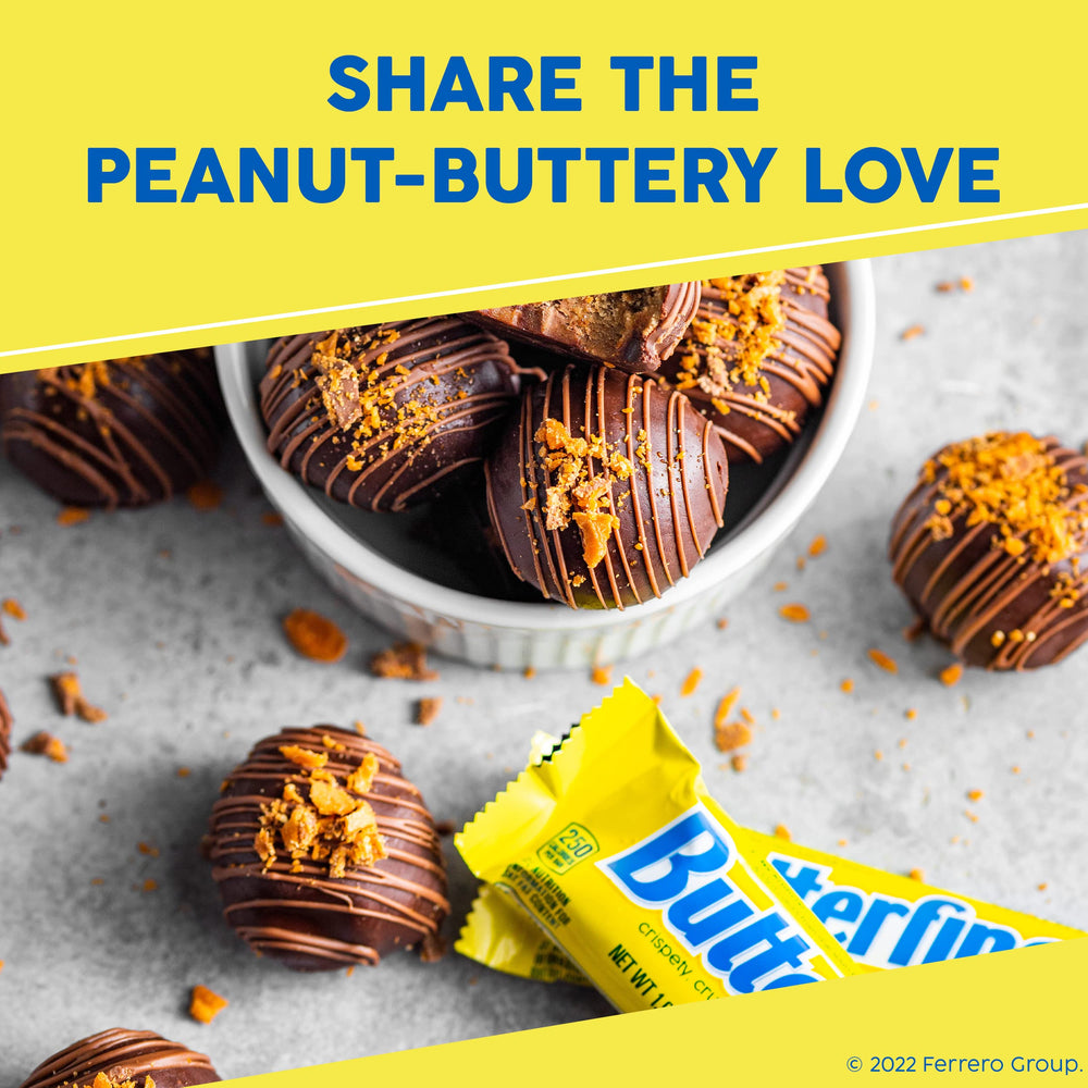 Hand holding Butterfinger bar for size comparison — full-size 1.9 oz serving