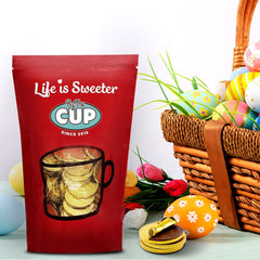By The Cup coins in decorative bowl demonstrating party-ready presentation