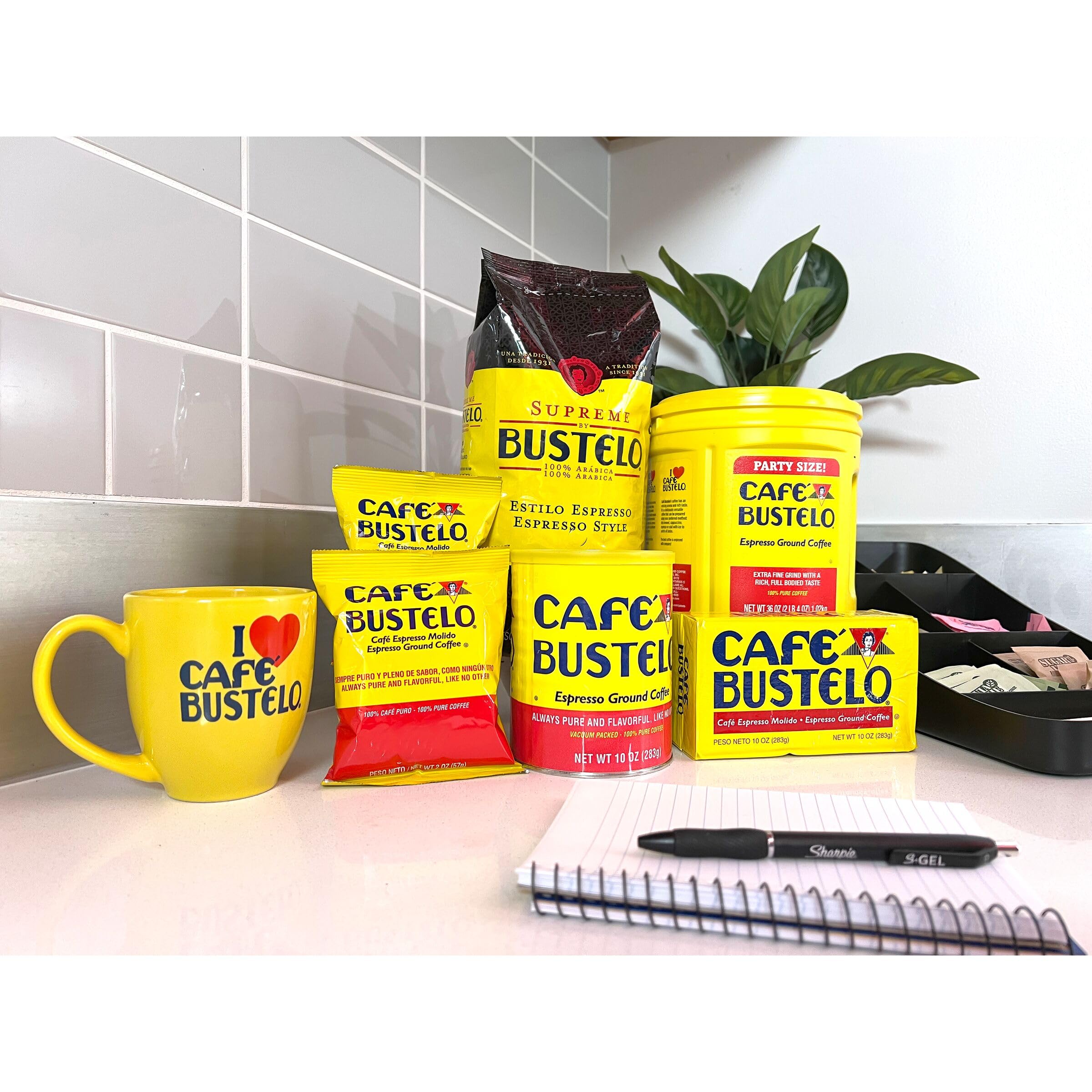 Six Café Bustelo canisters grouped to illustrate bulk supply convenience
