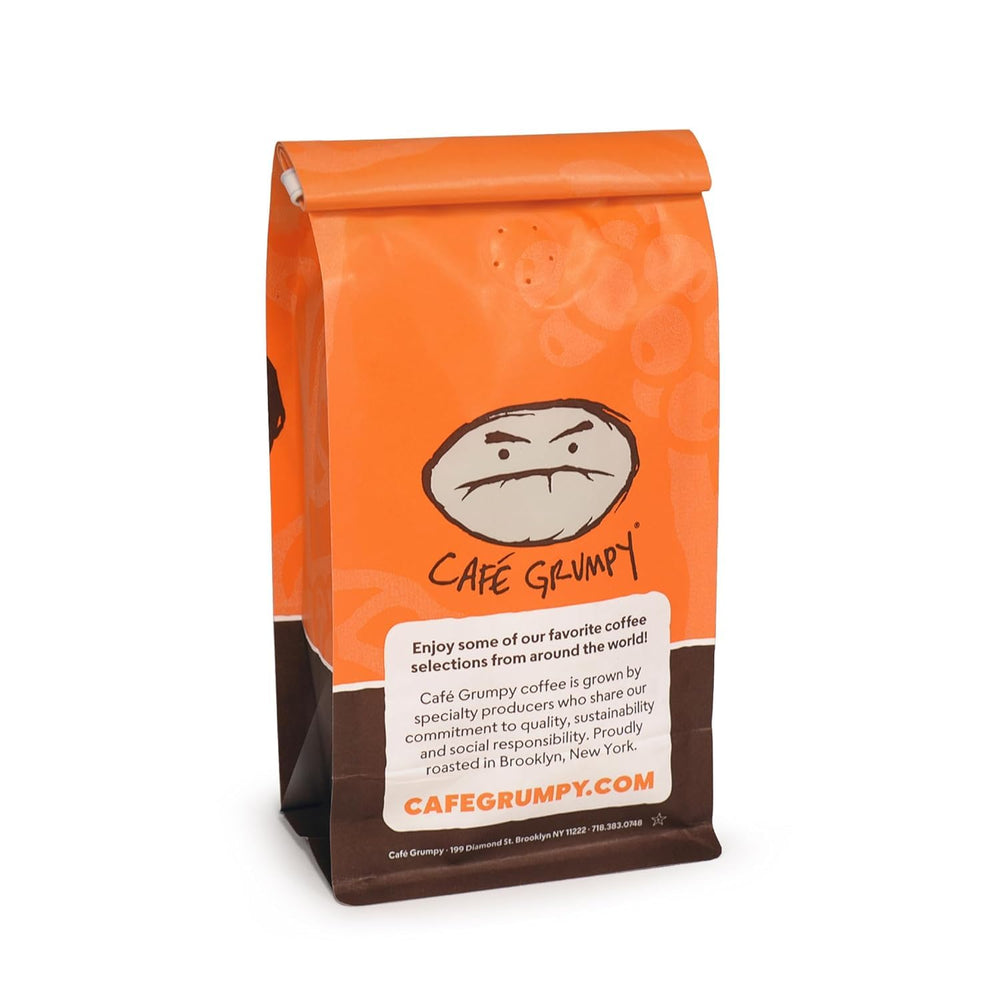 Café Grumpy cup beside dessert, indicates pairing and enjoyment