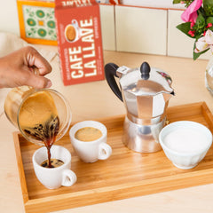 Cafe La Llave brewed espresso shot in demitasse capturing dark crema and intense aroma benefit: full-bodied flavor