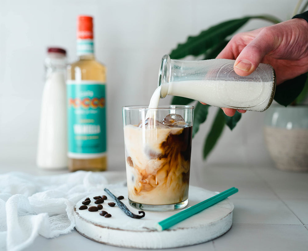 Cafe Pocco iced coffee with syrup visible, maintaining bright vanilla benefit