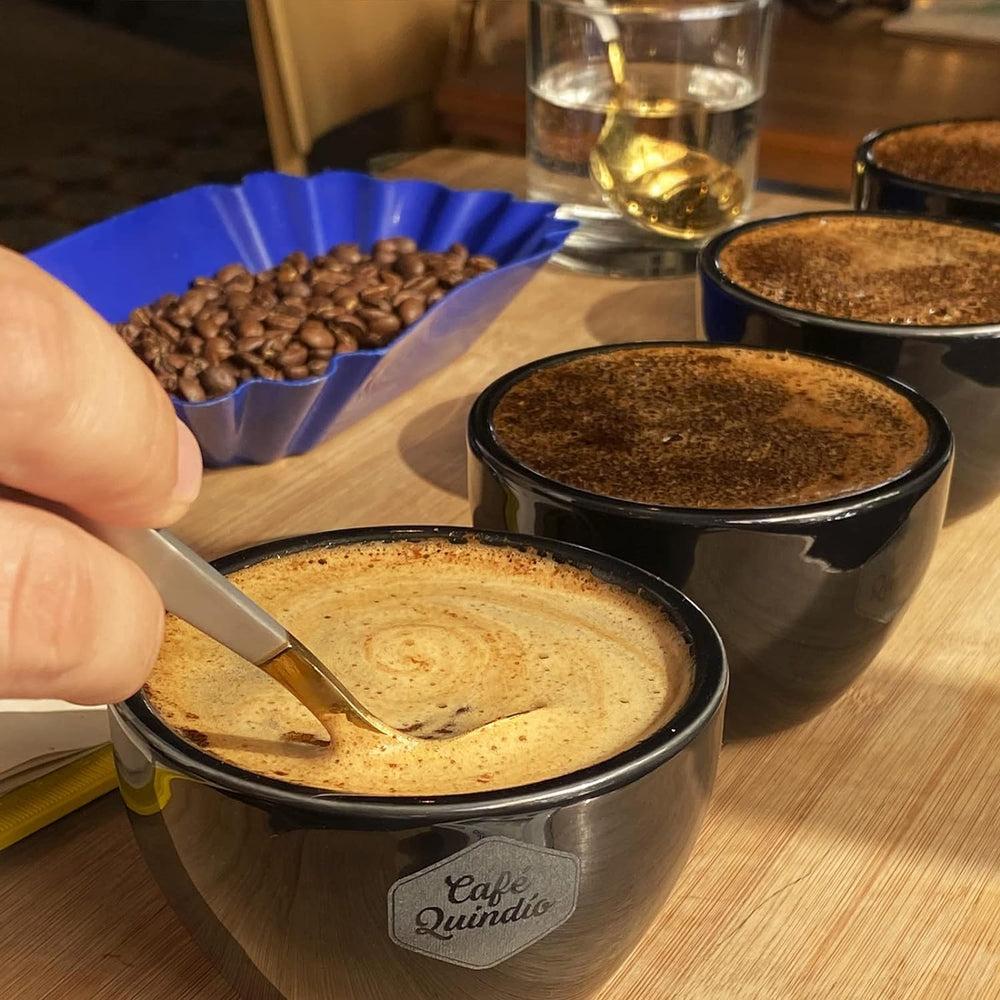 CAFE QUINDIO French press in use illustrating full-bodied low-acid cup