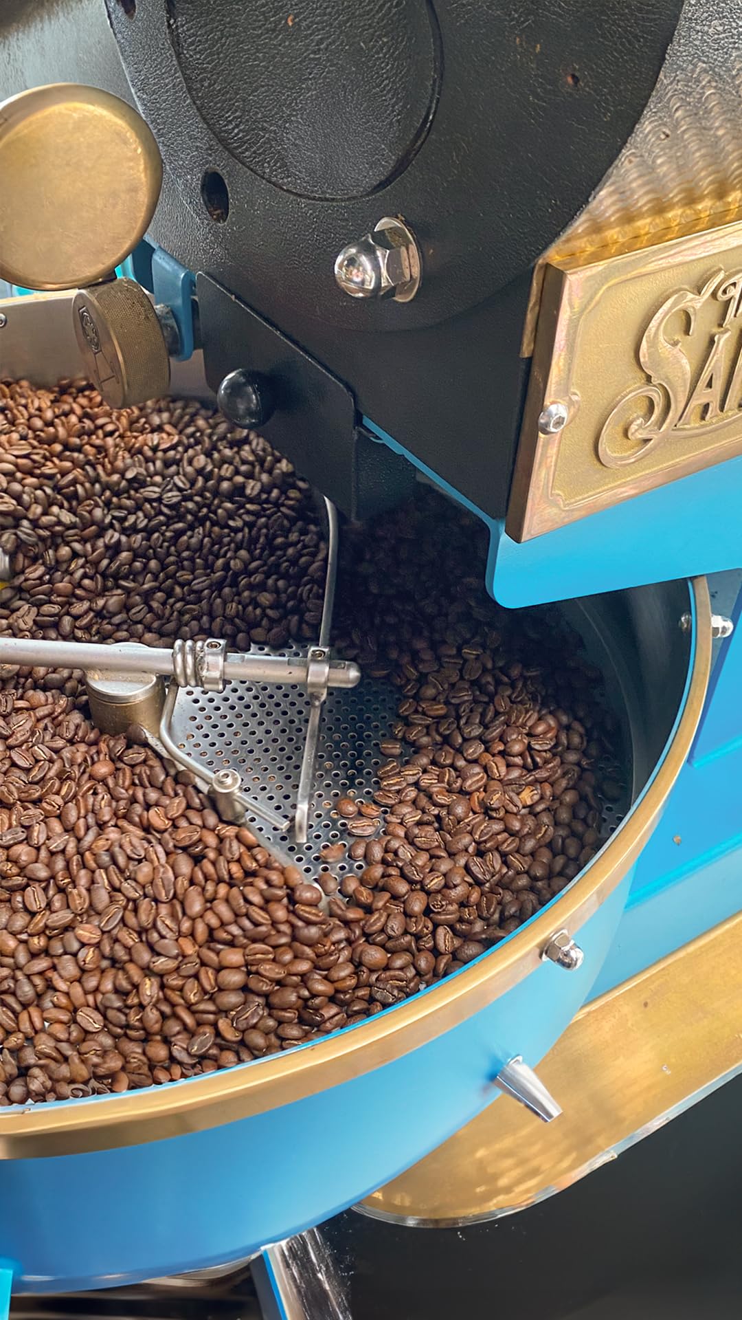 CAFE QUINDIO 12 oz bag next to common items for size and scale