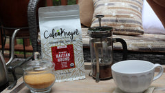 Cafe Kreyol 12 oz bag beside measuring scoop for size context, helps portioning decisions
