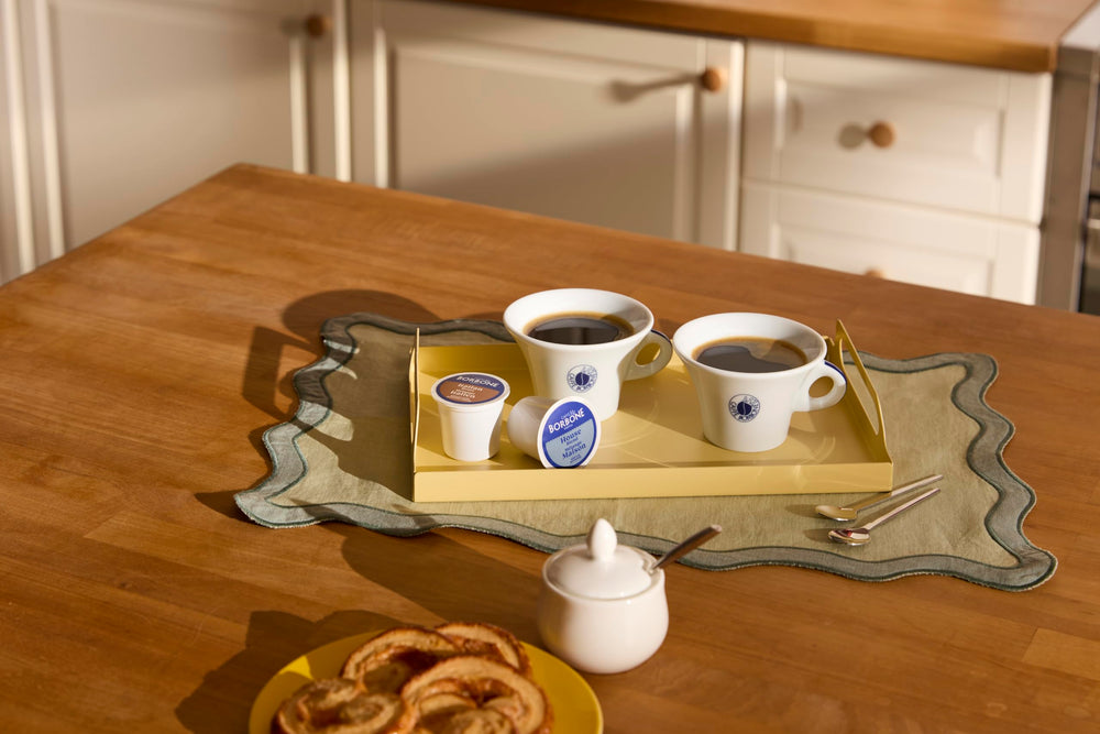 Caffè Borbone poured cup with milk foam showing rich flavor and smooth compatibility for lattes