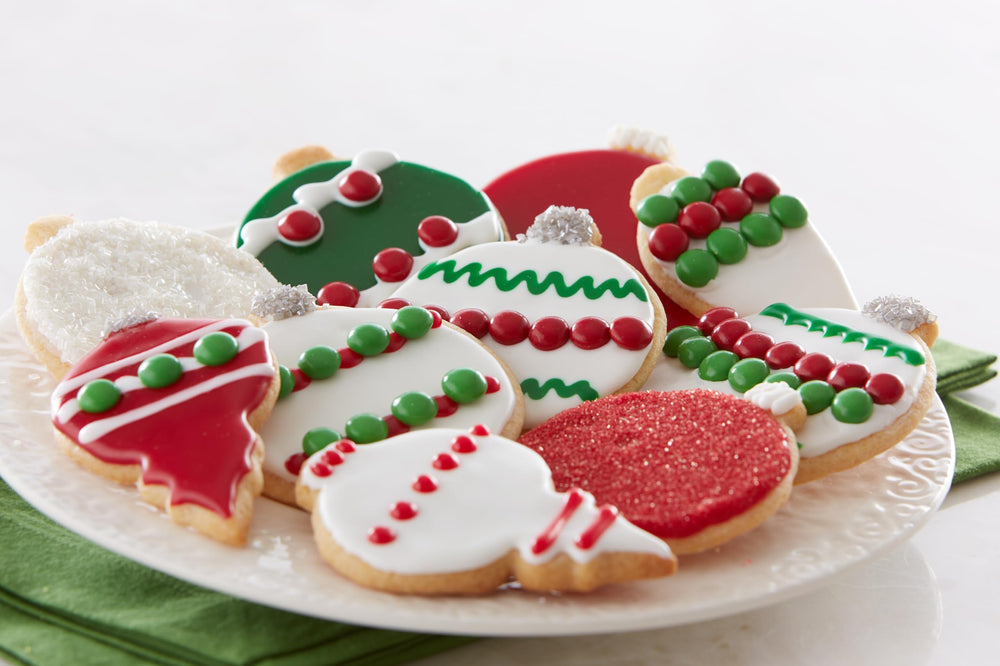 Cake Mate red sanding sugar used on cookies in a festive table setting for party-ready treats