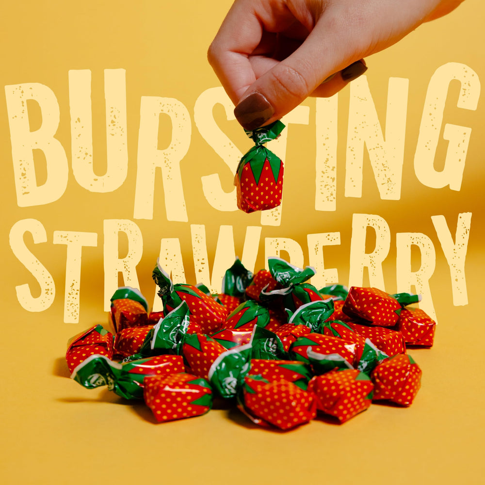 Cambie close-up of a single strawberry candy highlighting glossy shell and texture