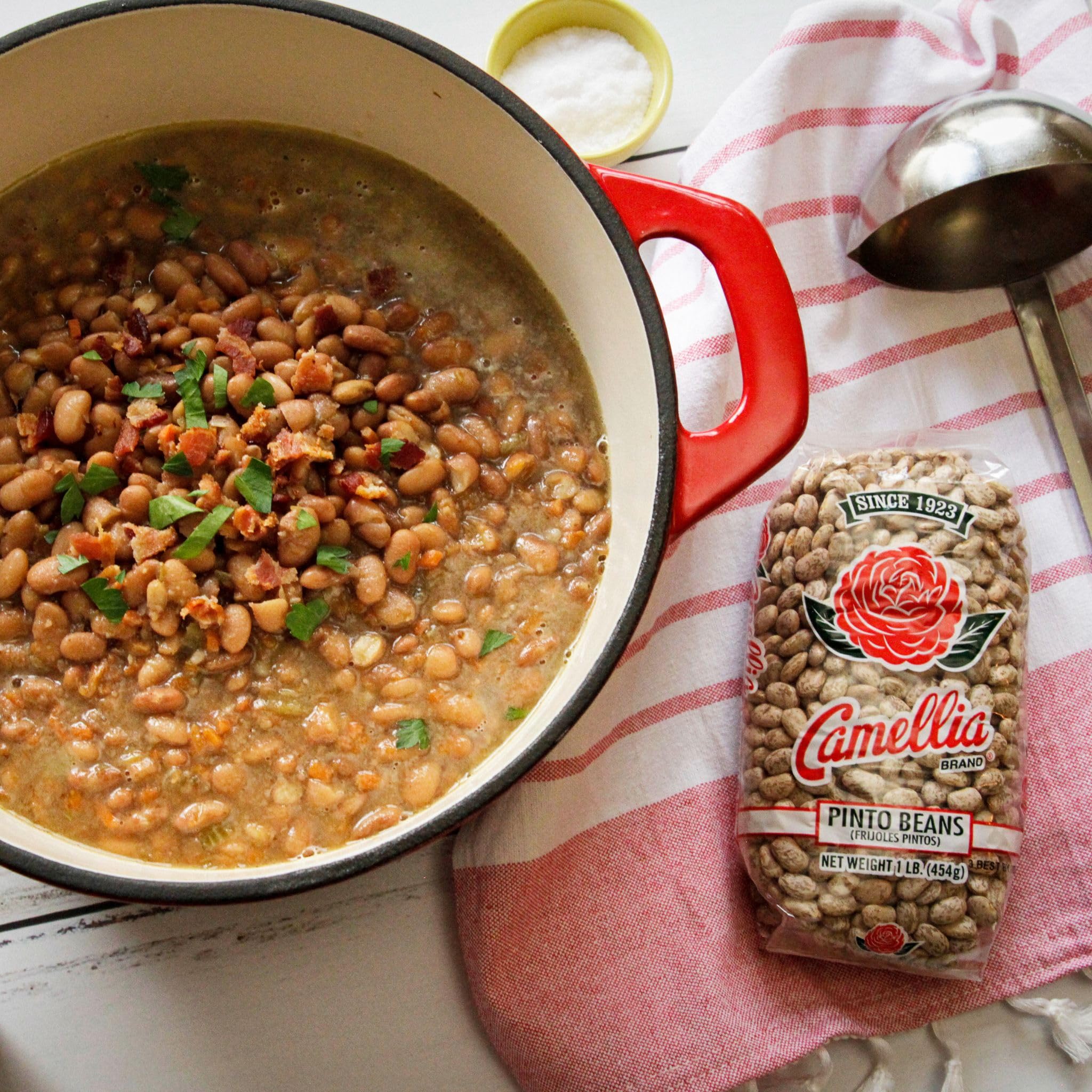 Measuring cup of Camellia Brand dry pintos portioned for recipe accuracy and meal prep