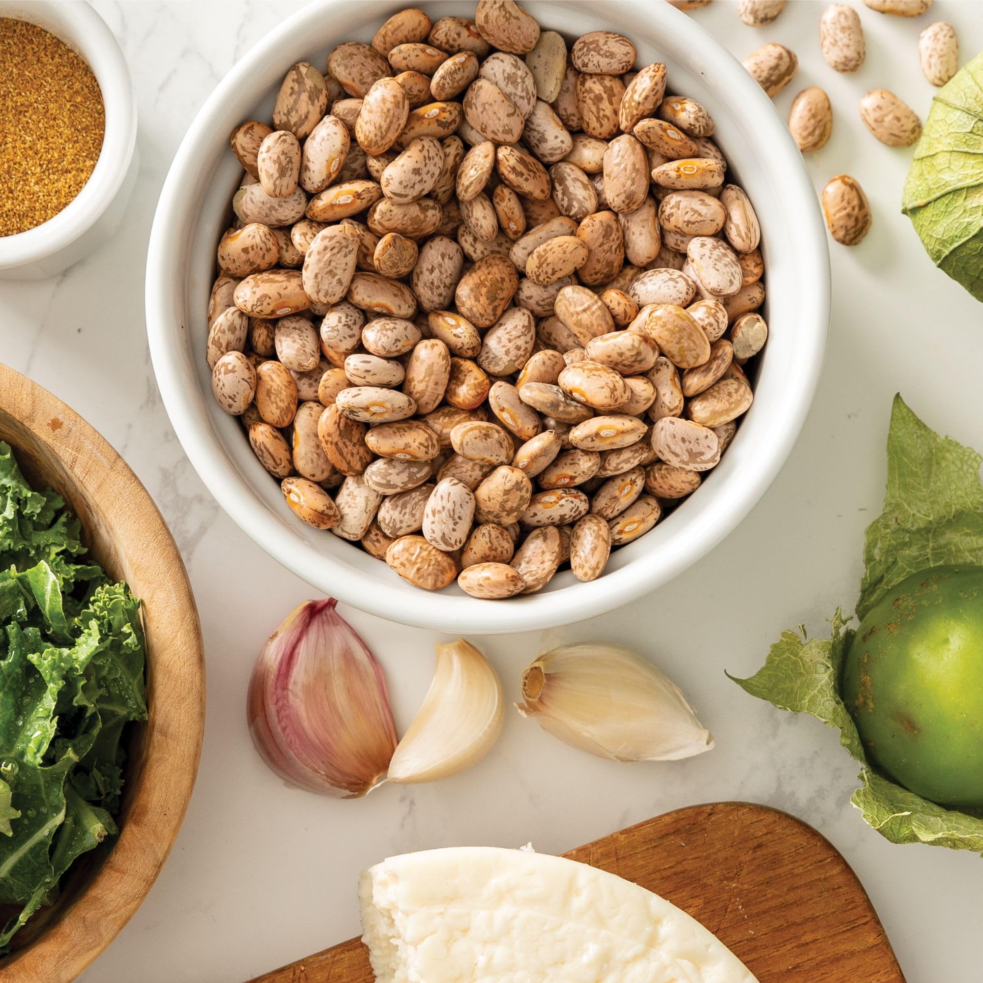 Refried beans prepared from Camellia Brand pintos plated with garnish, smooth and flavorful
