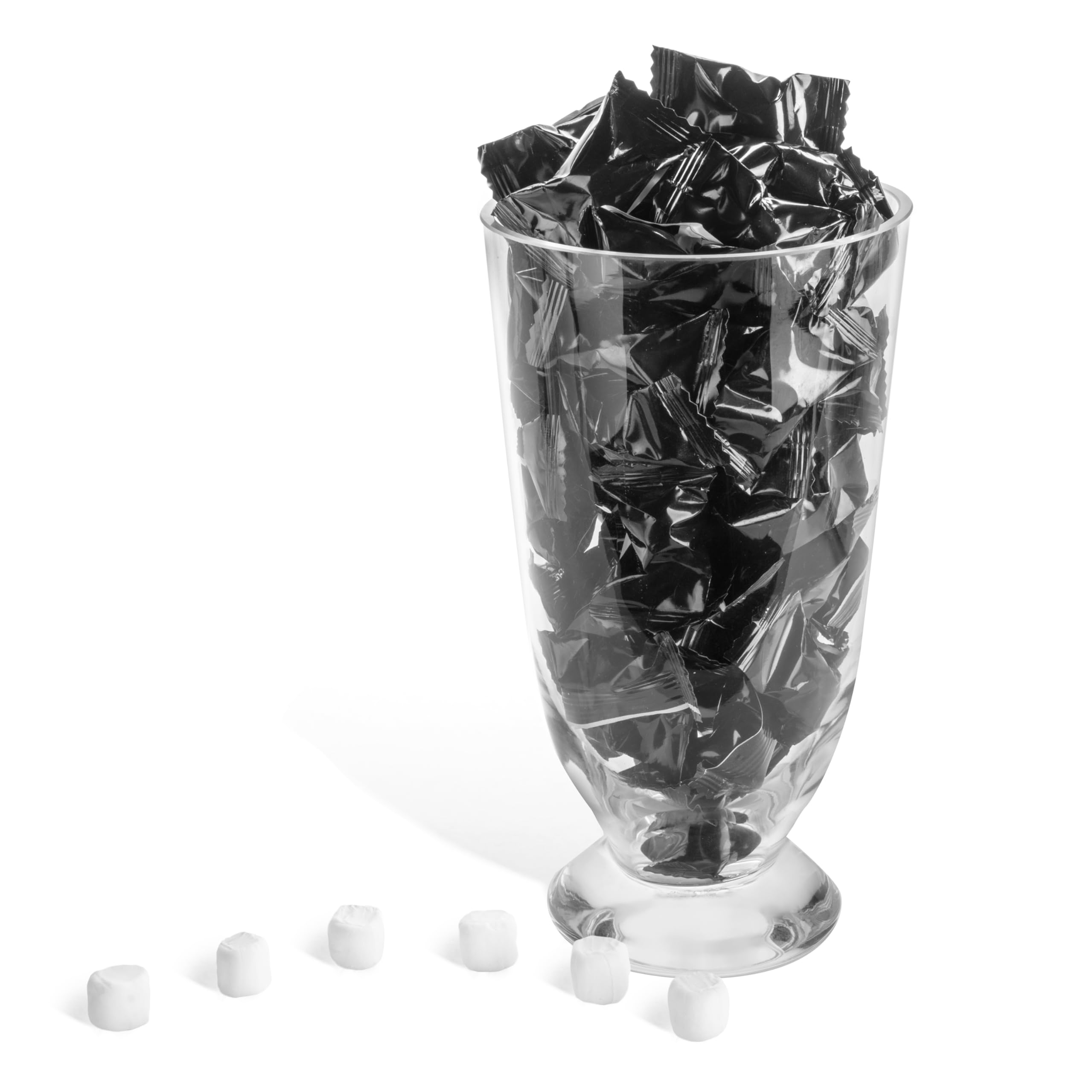 Candy Envy individual black wrapped mint on palm demonstrating convenient portioning
