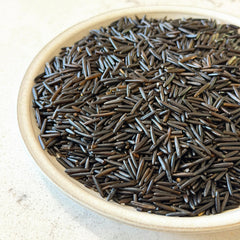 Canoe wild rice simmering in pot demonstrating firm grains and cooking result