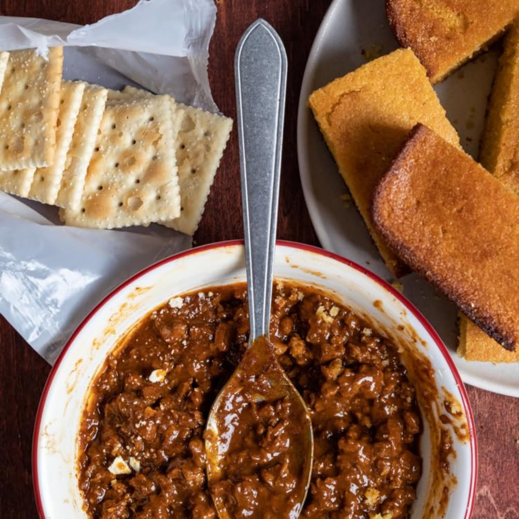 Burger topped with Carroll Shelby's seasoned chili, demonstrating bold flavor and tasty meal upgrade