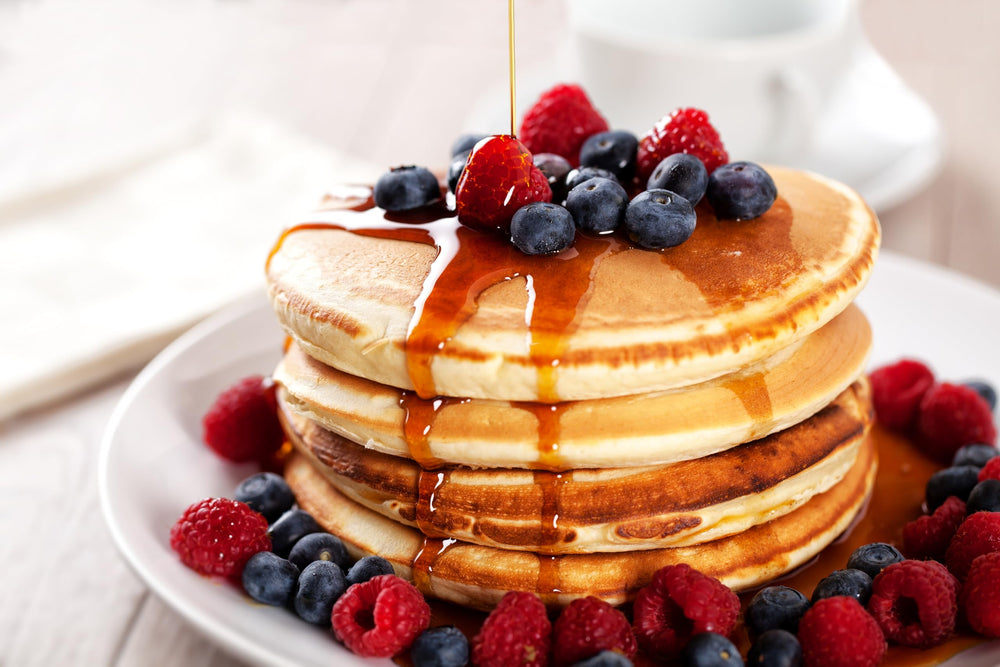 Cary's syrup pouring over a stack of pancakes adding flavor without added sugar