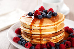 Cary's syrup pouring over a stack of pancakes adding flavor without added sugar