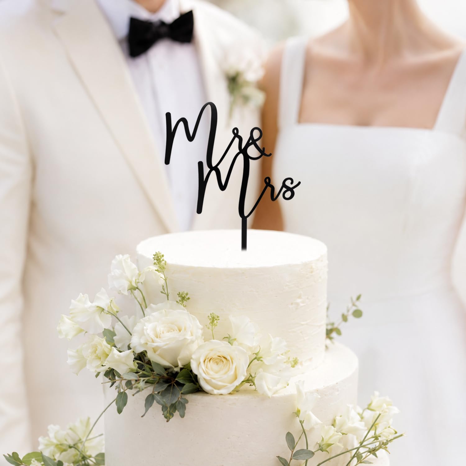 CC TOWN Mr & Mrs topper placed on a frosted wedding cake, enhances photo-friendly contrast