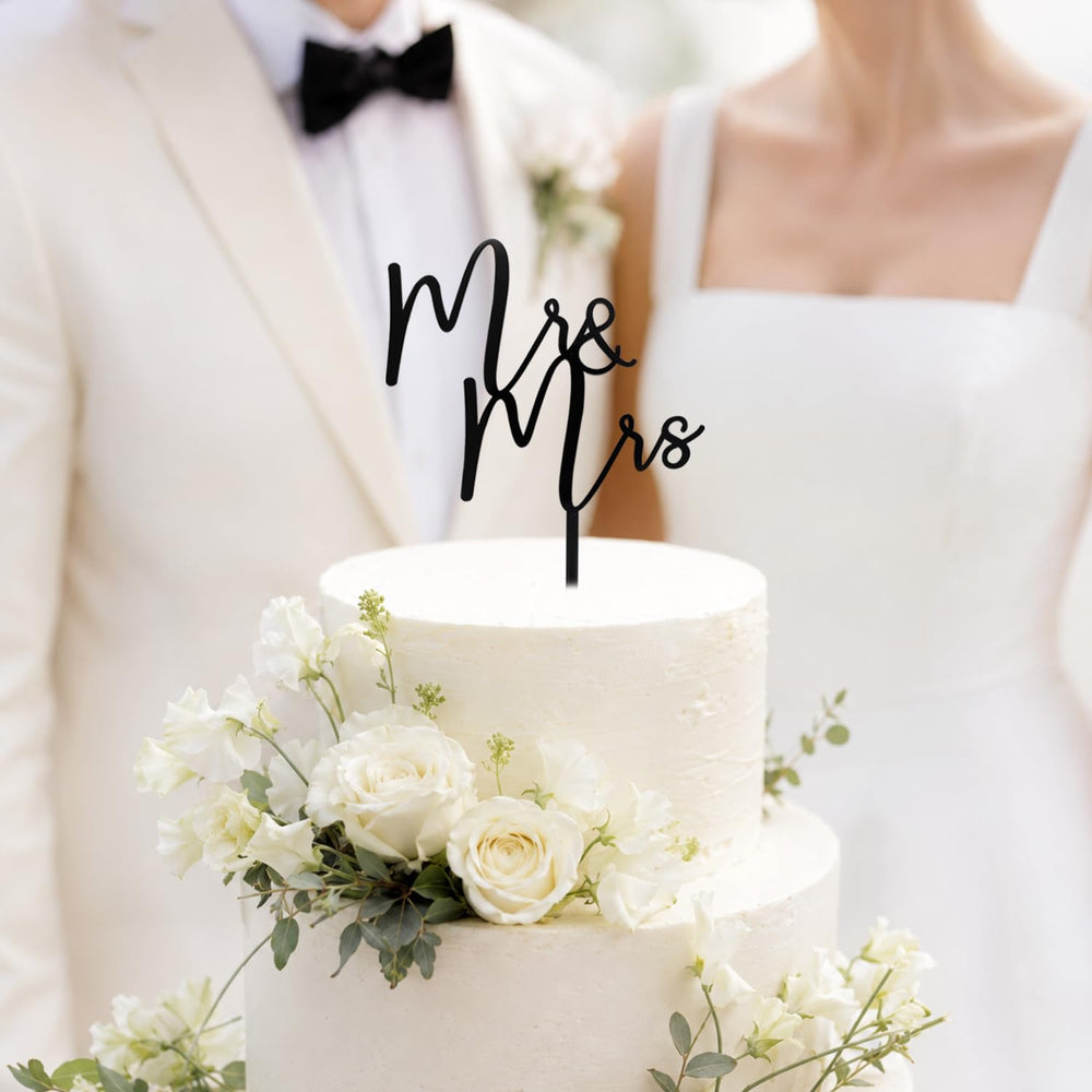 CC TOWN Mr & Mrs topper placed on a frosted wedding cake, enhances photo-friendly contrast