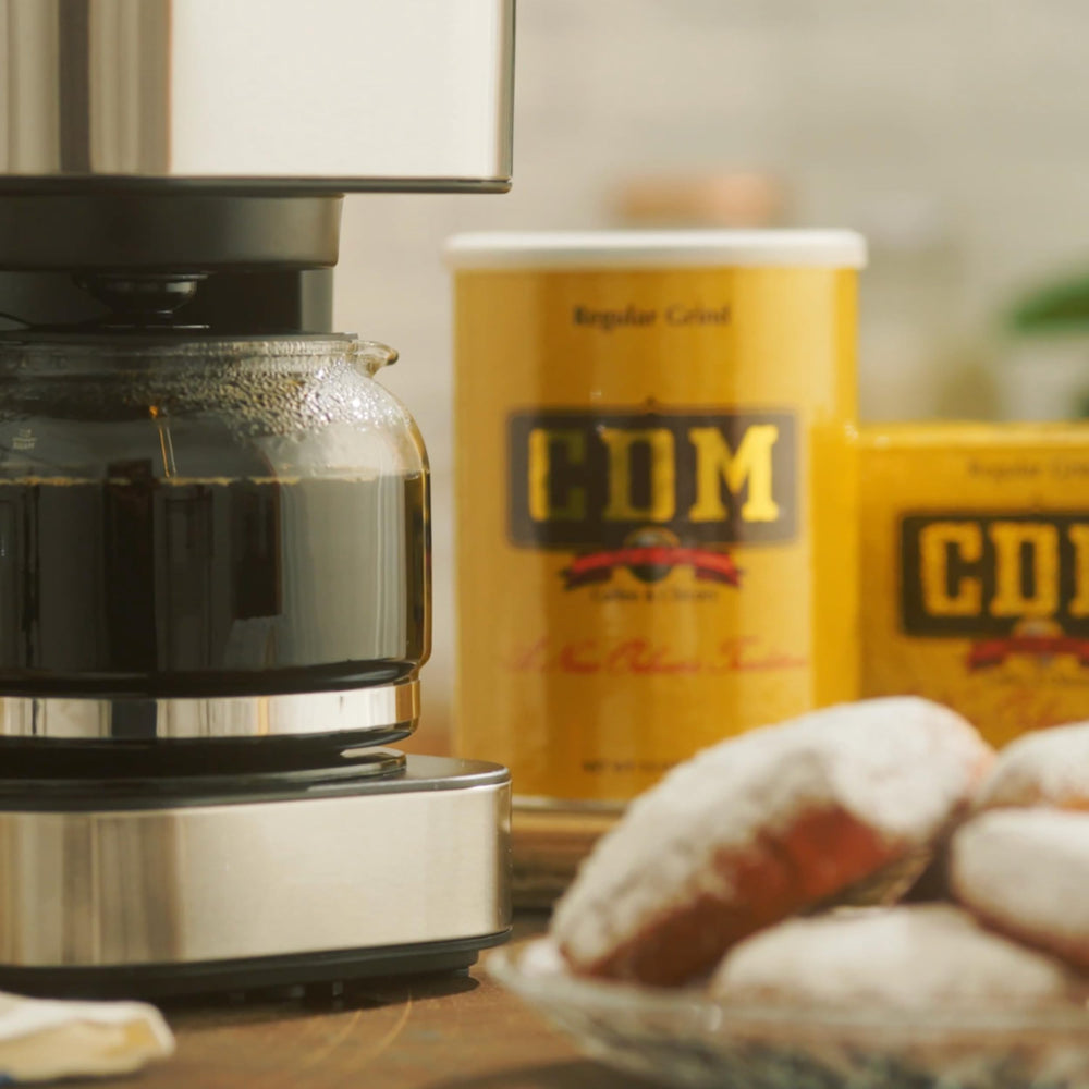 CDM grounds pouring into drip filter demonstrating easy brewing