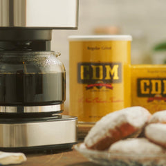 CDM grounds pouring into drip filter demonstrating easy brewing