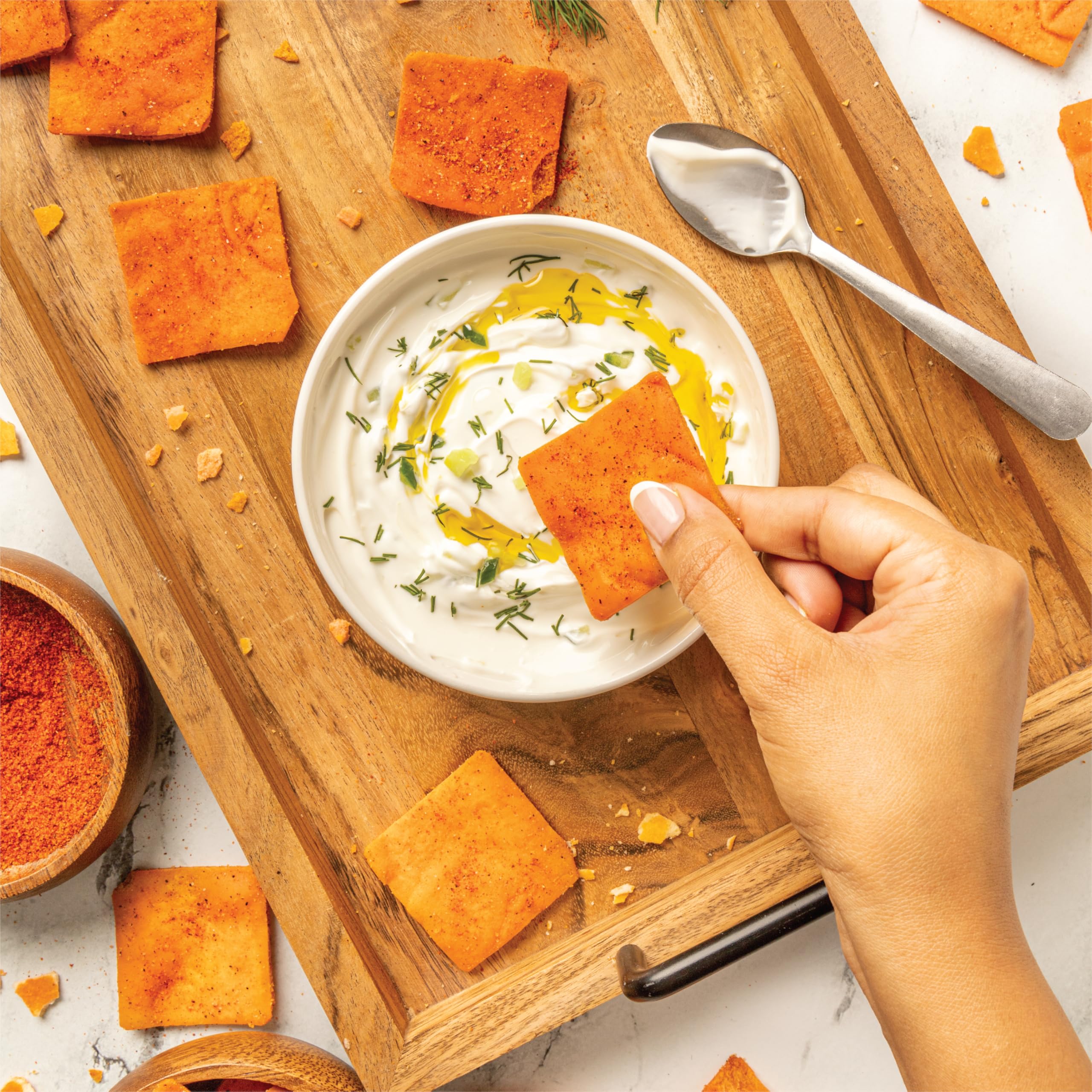Cedar Valley pita chips in a bowl beside dip for convenient sharing
