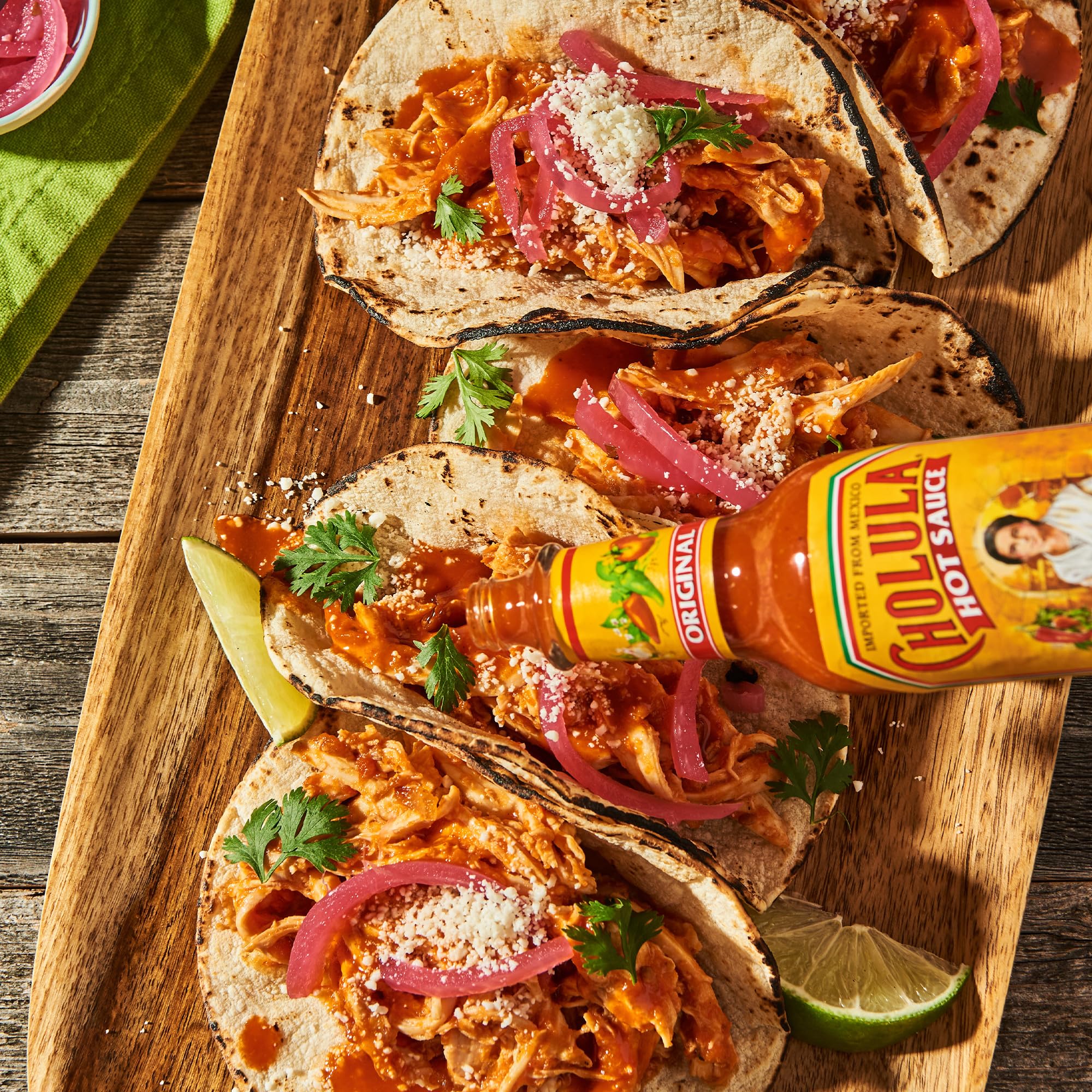 Cholula bottle with ruler scale showing bottle size and portion control